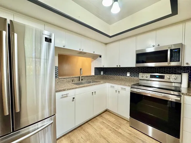 a kitchen with a stove microwave and a sink