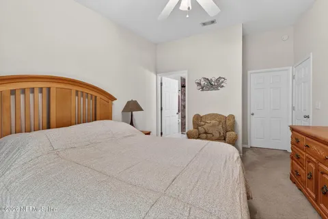 a bedroom with a bed and a lamp
