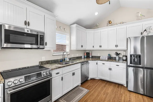 a bathroom with a granite countertop toilet sink and mirror
