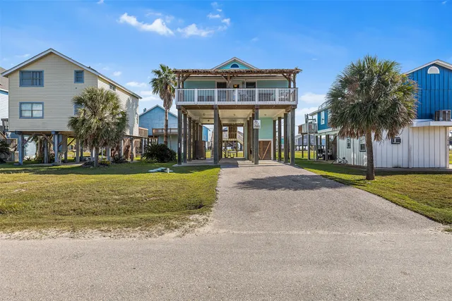 a view of a chairs and table in patio with wooden floor