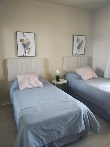 a bedroom with a bed and a painting on the wall