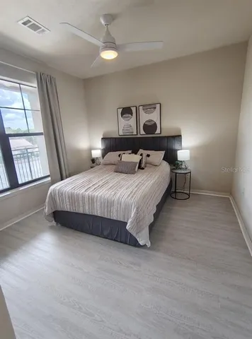 a bedroom with a bed and window