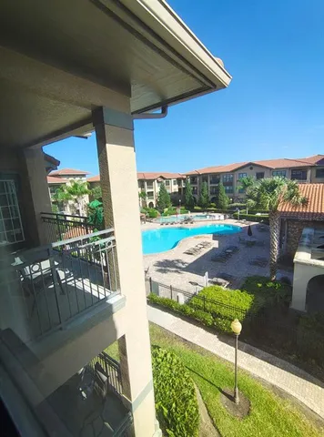 a view of a patio with chairs and a table