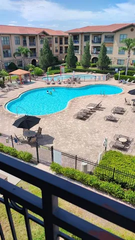 a view of swimming pool with outdoor seating and a potted plant