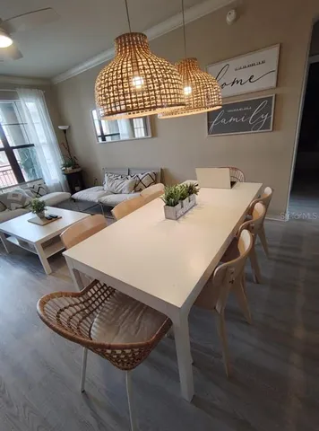 a dining room with furniture and a window