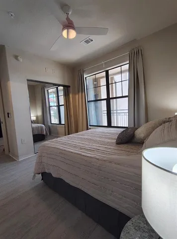 a bedroom with a bed and window