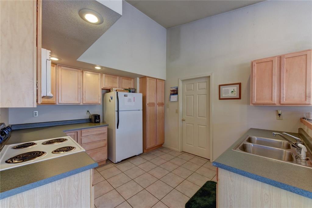2315 Singletree Road Hartsel, CO 80449 - Photo 13 of 30 a kitchen with a refrigerator and a sink