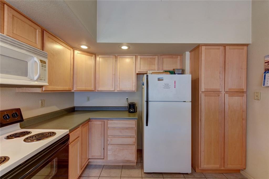 2315 Singletree Road Hartsel, CO 80449 - Photo 14 of 30 a kitchen with a refrigerator a stove and cabinets