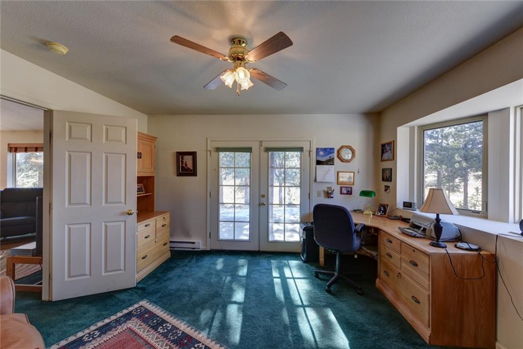 2315 Singletree Road Hartsel, CO 80449 - Photo 19 of 30 a living room with furniture and large windows