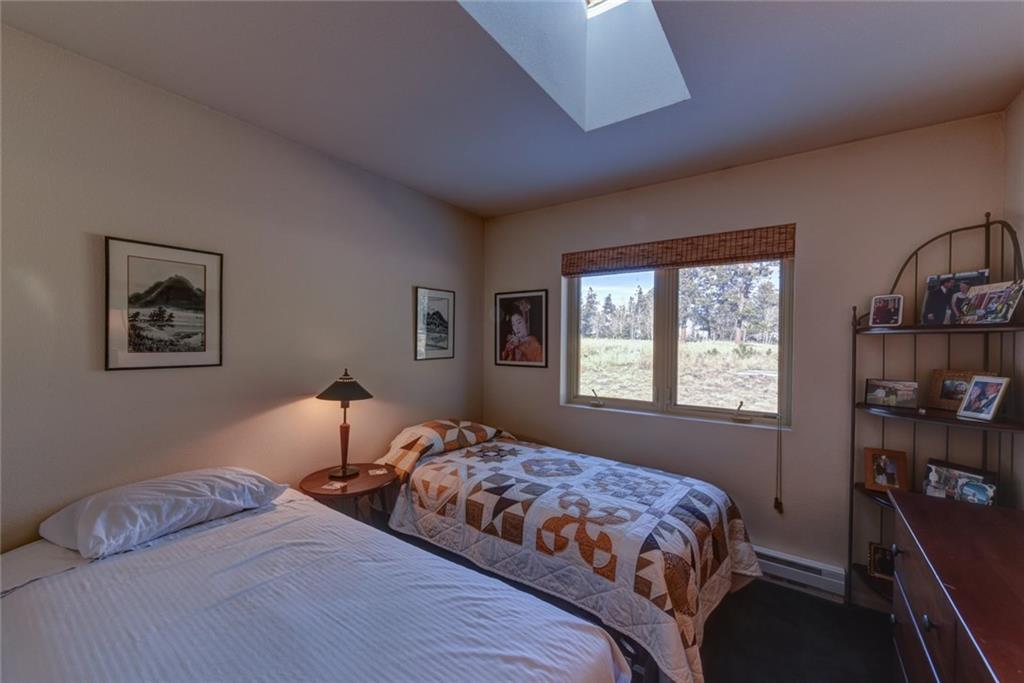 2315 Singletree Road Hartsel, CO 80449 - Photo 21 of 30 a bedroom with bed and a window