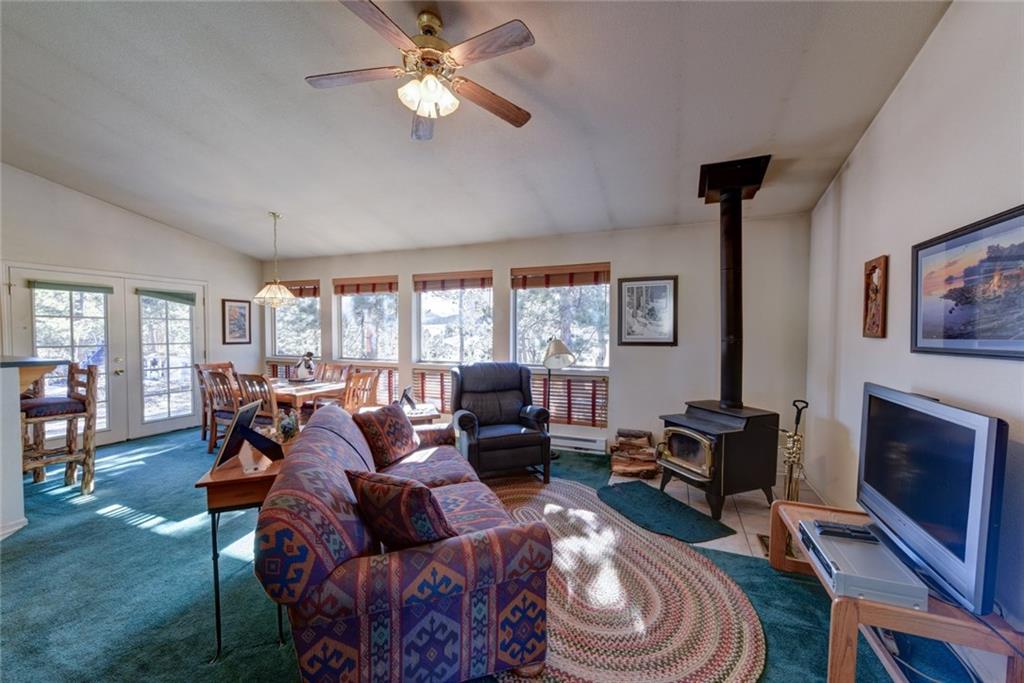 2315 Singletree Road Hartsel, CO 80449 - Photo 7 of 30 a living room with furniture a fireplace and a window