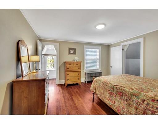 21 Homewood Road Boston, MA 02132 - Photo 16 of 25 a bedroom with a bed next to a window with wooden floor