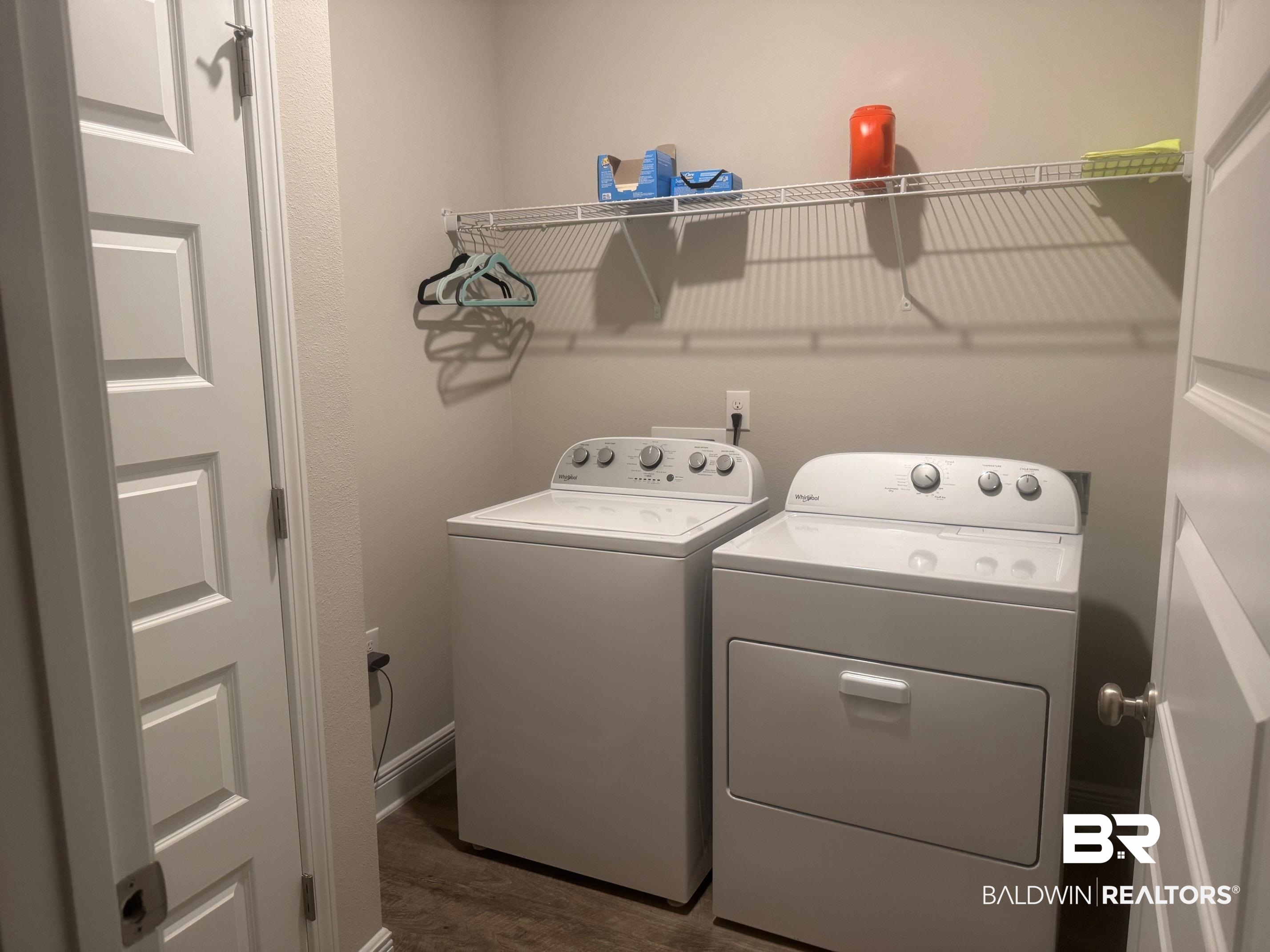 24903 Spectacular Bid Loop Daphne, AL 36526 - Photo 27 of 37 Washroom featuring washer and clothes dryer and dark wood finished floors