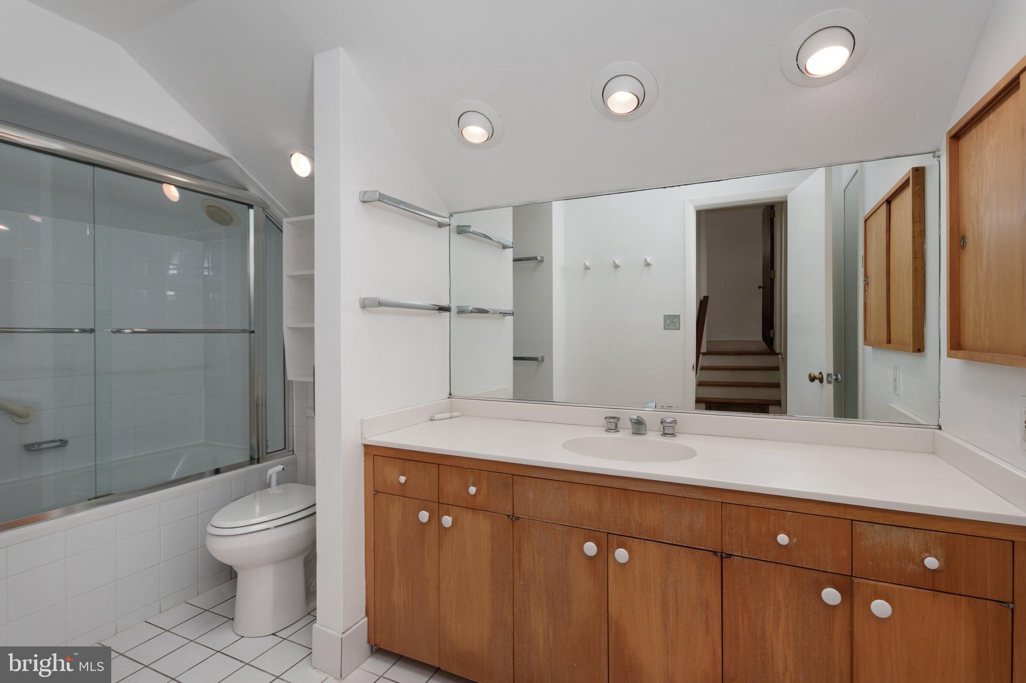 505 Prospect Avenue Princeton, NJ 08540 - Photo 19 of 28 a spacious bathroom with a granite countertop sink toilet a large mirror a shower and a bathtub