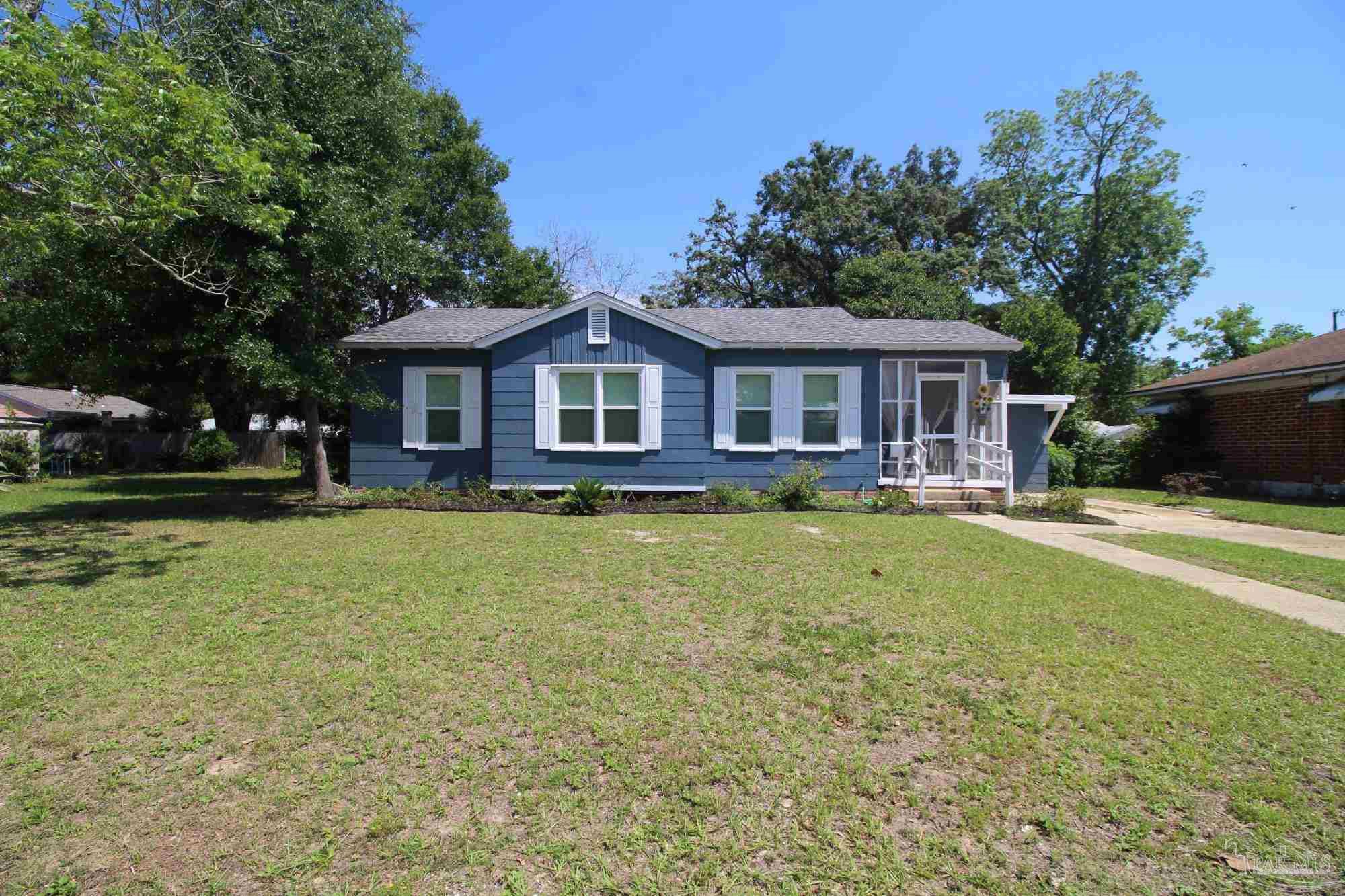 a front view of a house with swimming pool having outdoor seating