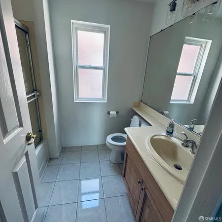 a bathroom with a sink a toilet and mirror