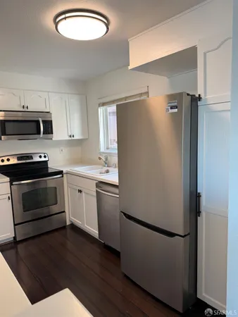 a white refrigerator freezer sitting in a kitchen