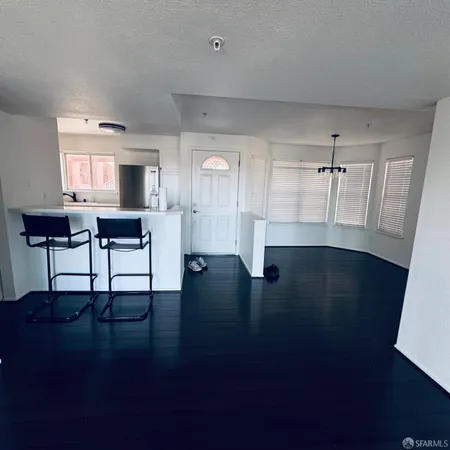 a view of kitchen with furniture and wooden floor