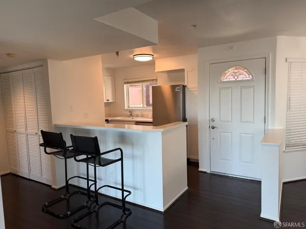 a kitchen with stainless steel appliances granite countertop a refrigerator and a stove top oven