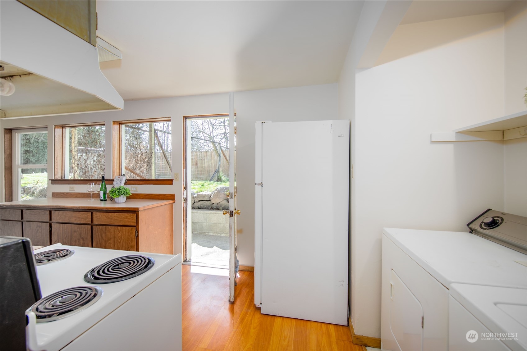 2018 11th Street Bremerton, WA 98337 - Photo 30 of 35 a kitchen with a refrigerator a stove cabinets and wooden floor