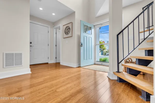 a view of an entryway with wooden floor