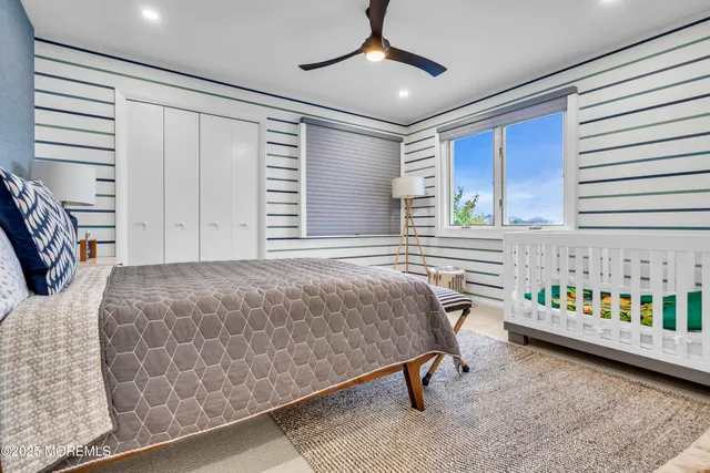 a bedroom with a bed window and a ceiling fan