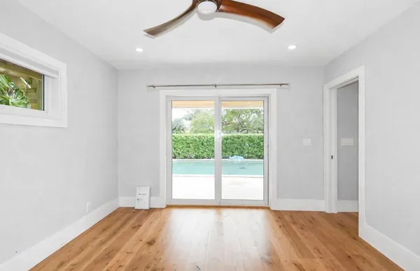 a bathroom with a granite countertop sink a mirror and shower