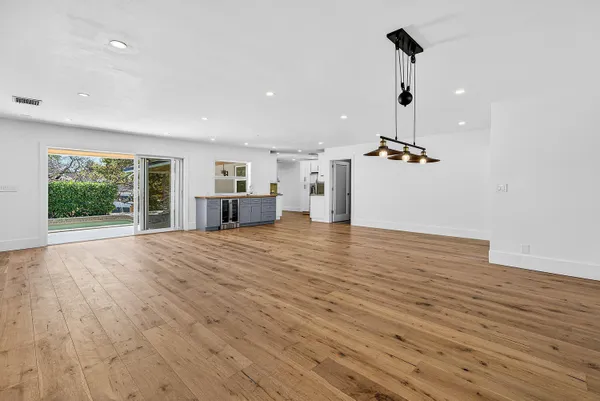 a kitchen with stainless steel appliances granite countertop a stove a refrigerator and a sink