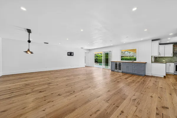 a kitchen with granite countertop a sink cabinets stainless steel appliances and a window