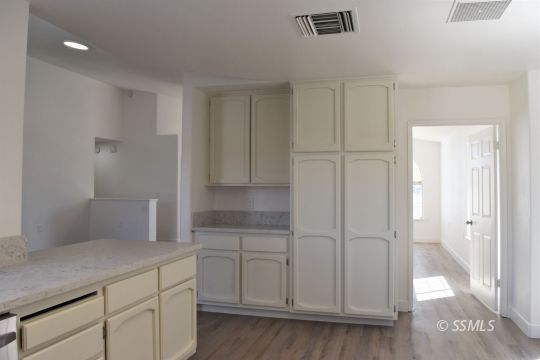 1132 West Robert Avenue Ridgecrest, CA 93555 - Photo 15 of 38 a view of a kitchen with white cabinets