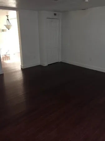 a view of an empty room and wooden floor