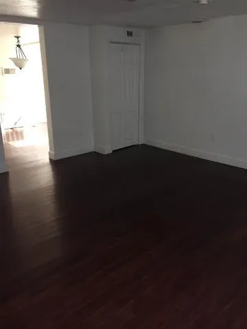 a view of an empty room and wooden floor