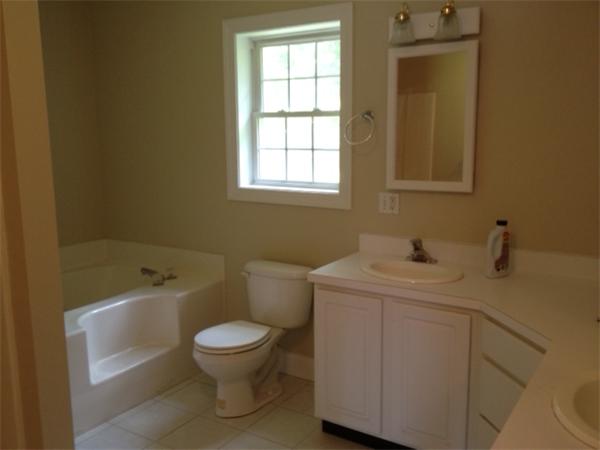 245 Edgell Road Framingham, MA 01701 - Photo 6 of 8 a bathroom with a granite countertop toilet a sink and a bathtub
