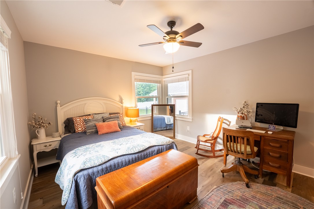 103 Riggs Drive Clemson, SC 29631 - Photo 24 of 50 Well-lit sleeping quarters with a ceiling fan, durable flooring, and ample natural light from multiple windows.