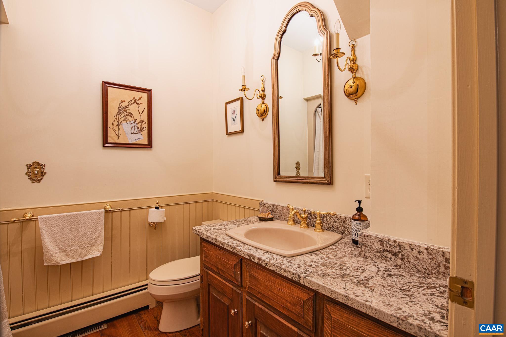263 Baynes Road Waynesboro, VA 22980 - Photo 38 of 74 a bathroom with a granite countertop sink a toilet and a mirror