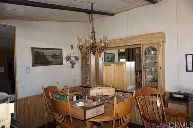 42974 Manatee Street Newberry Springs, CA 92365 - Photo 13 of 20 a view of a dining room with furniture and chandelier