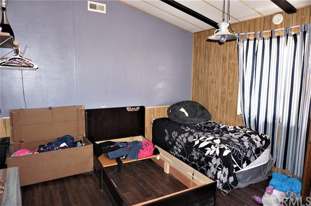 42974 Manatee Street Newberry Springs, CA 92365 - Photo 5 of 20 a bed room with a bed and a chair