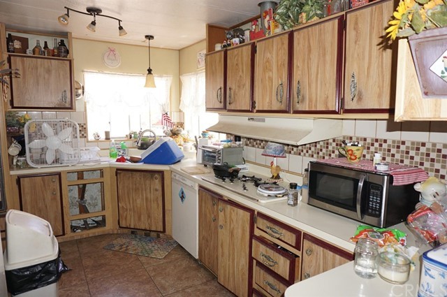 42974 Manatee Street Newberry Springs, CA 92365 - Photo 10 of 20 a kitchen with stainless steel appliances a stove a sink and a microwave