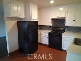 a kitchen with a refrigerator and a stove