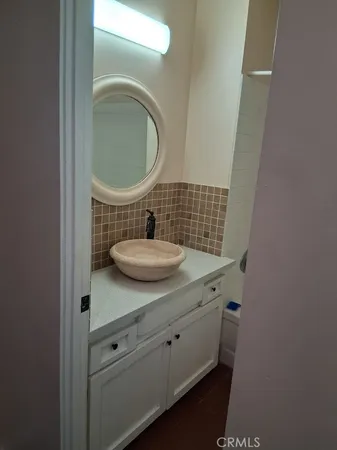 a bathroom with a sink toilet and mirror