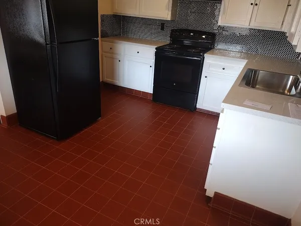a kitchen with a sink and a refrigerator