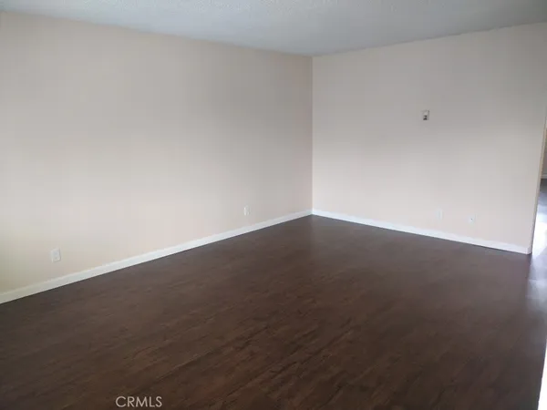 an empty room with wooden floor