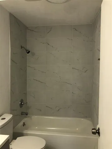 a bathroom with a bathtub and a toilet