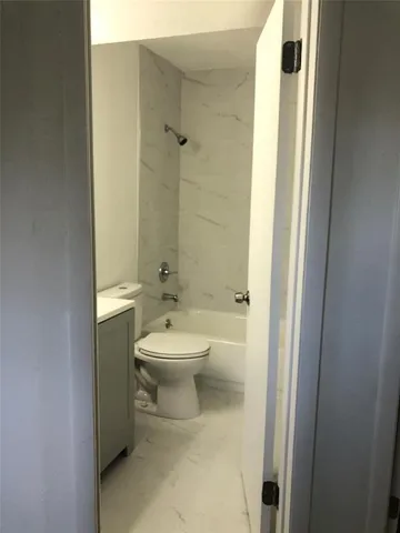 a bathroom with a toilet sink and shower
