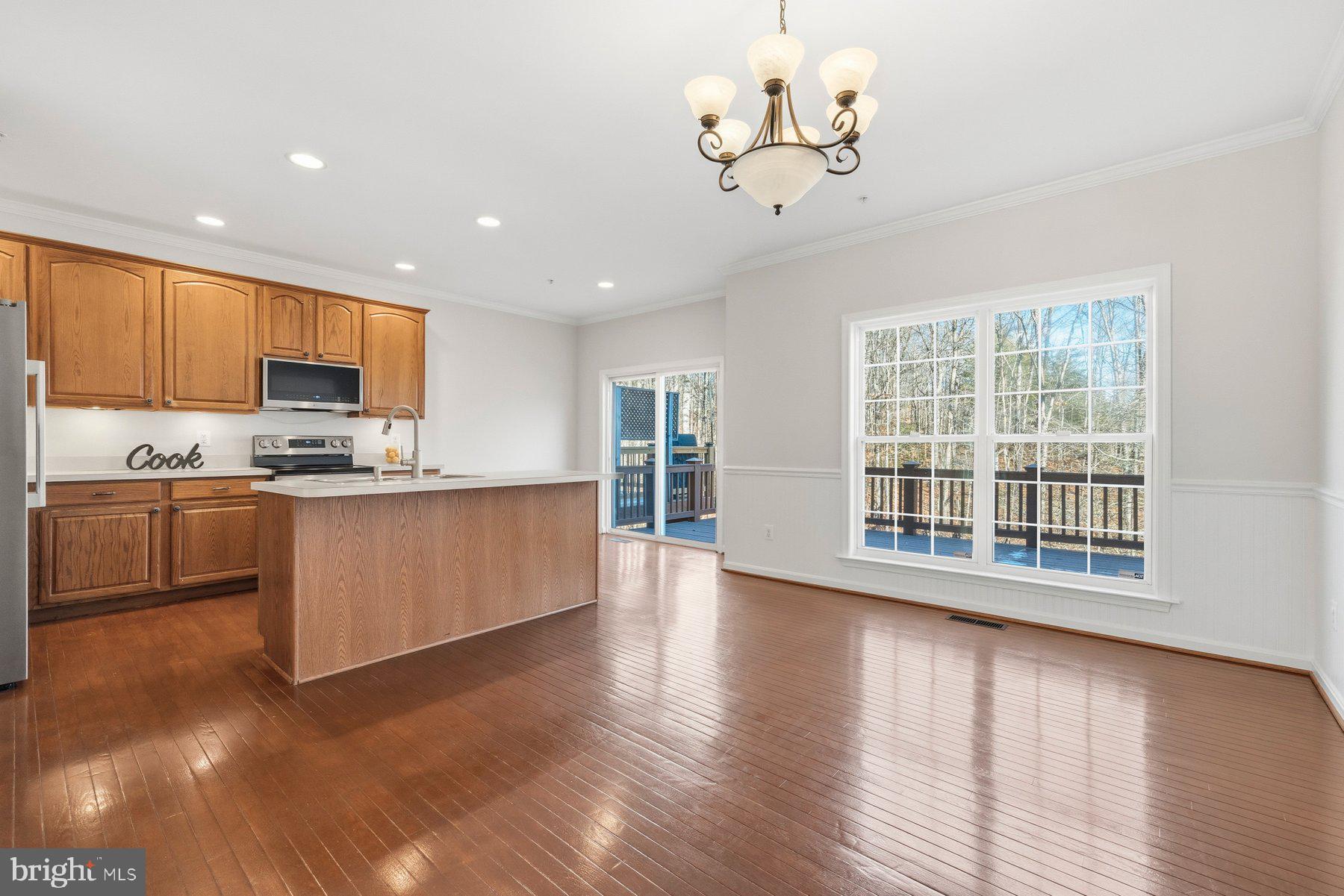 2640 Streamview Drive Odenton, MD 21113 - Photo 11 of 73 a large kitchen with stainless steel appliances granite countertop a large counter top and wooden floors
