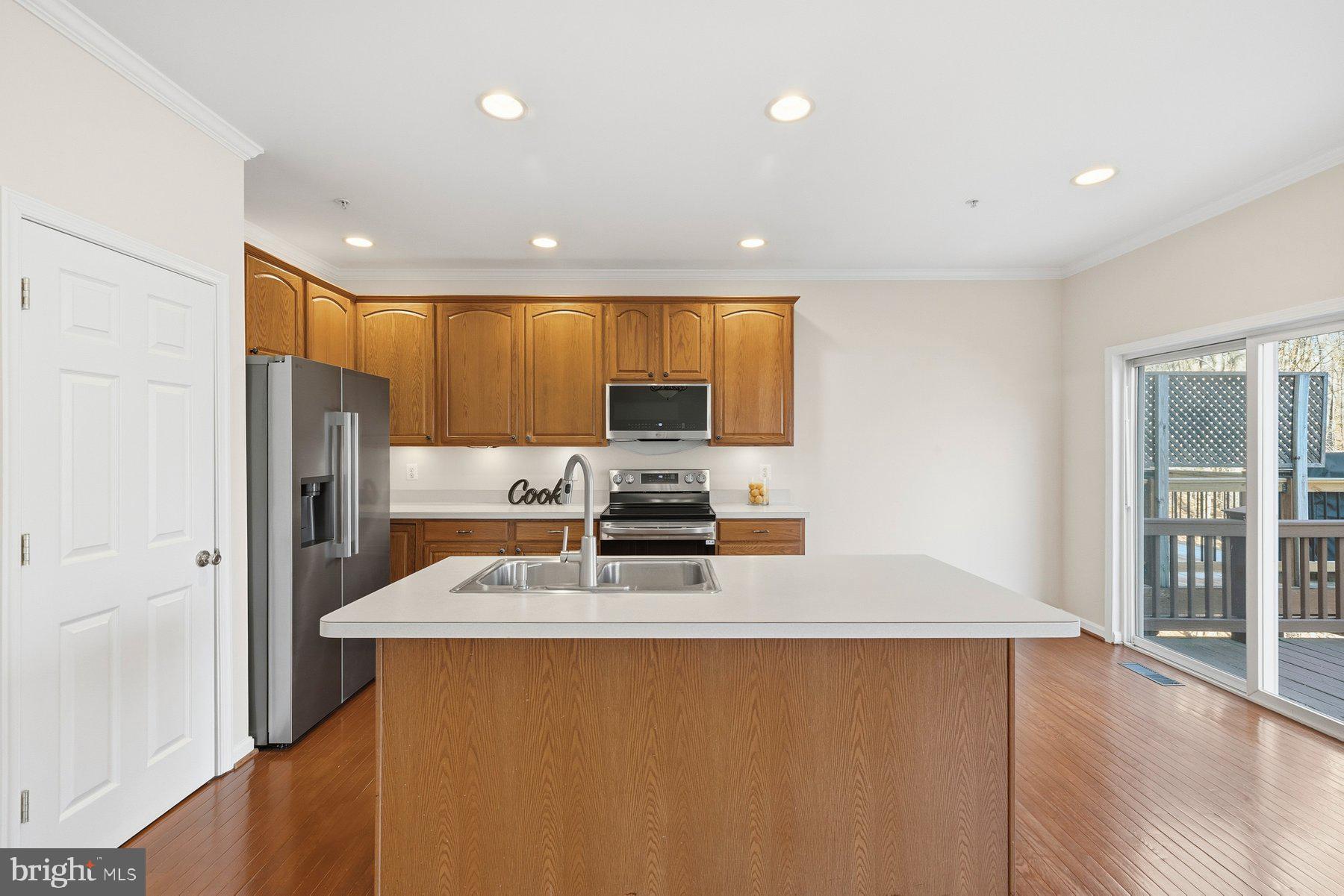 2640 Streamview Drive Odenton, MD 21113 - Photo 13 of 73 a kitchen with stainless steel appliances a microwave a stove a refrigerator white cabinets and wooden floor