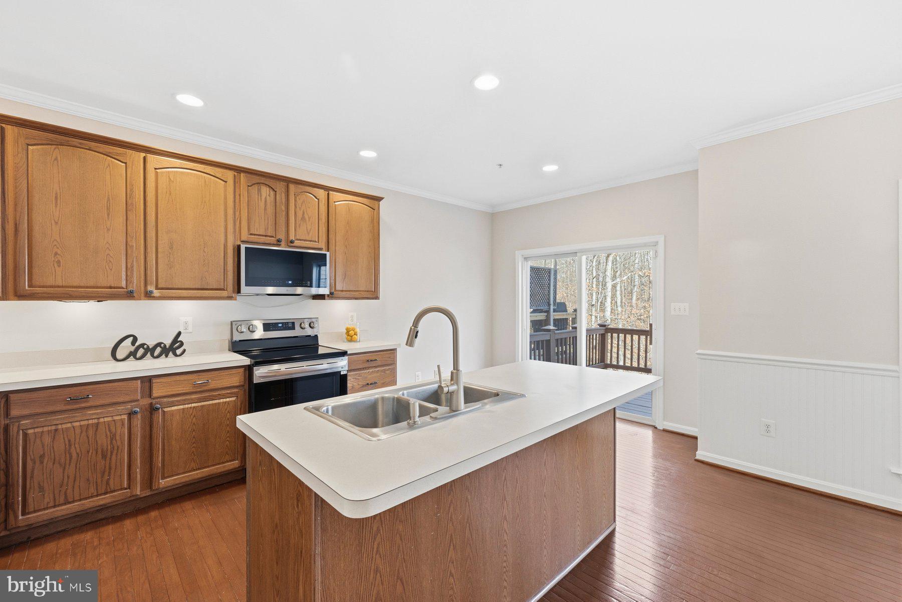 2640 Streamview Drive Odenton, MD 21113 - Photo 14 of 73 a kitchen with a sink a stove a microwave and cabinets