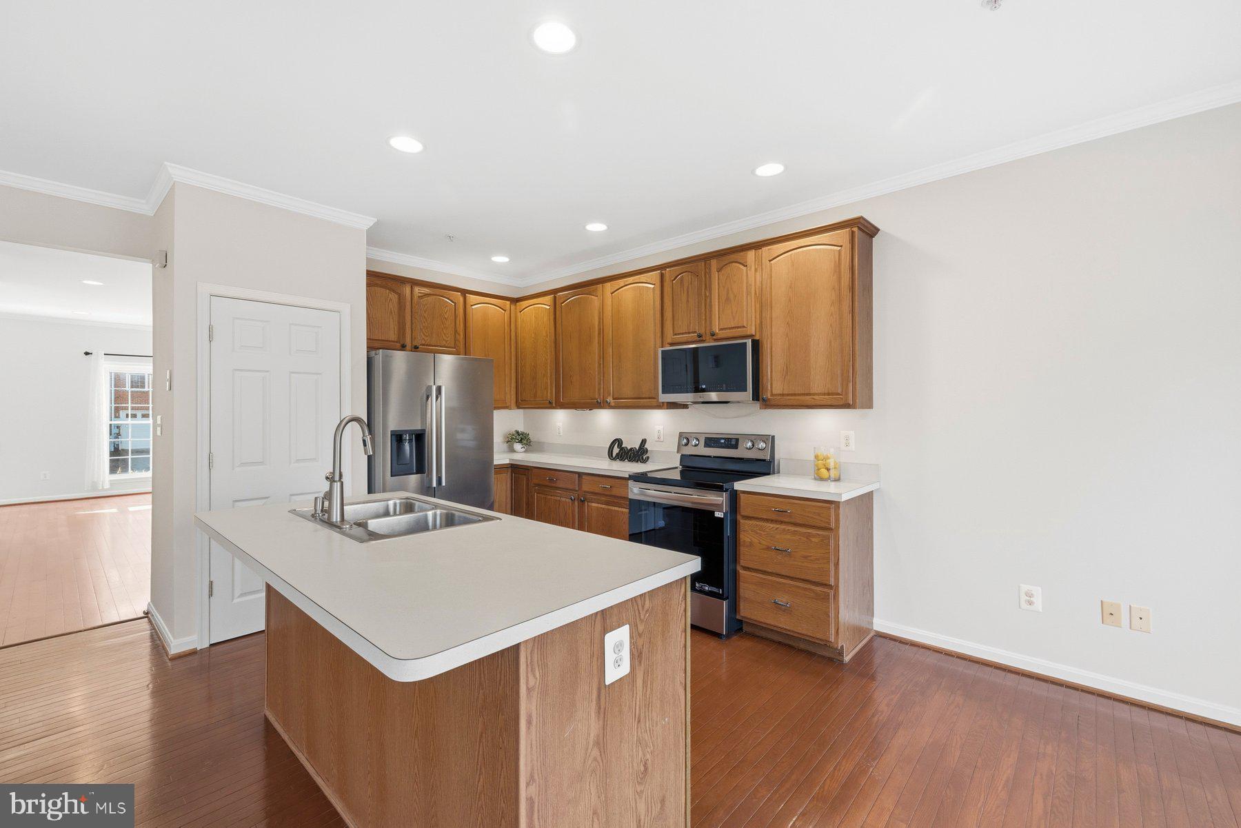 2640 Streamview Drive Odenton, MD 21113 - Photo 15 of 73 a kitchen with a sink a stove a refrigerator cabinets and a window