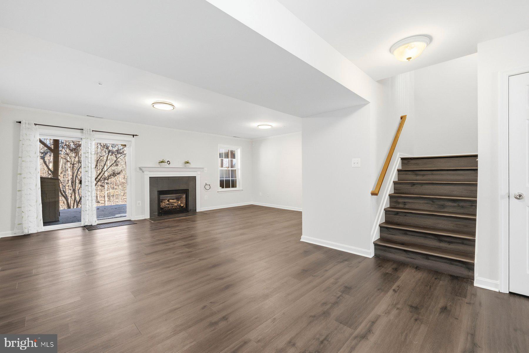 2640 Streamview Drive Odenton, MD 21113 - Photo 33 of 73 an empty room with wooden floor and fireplace