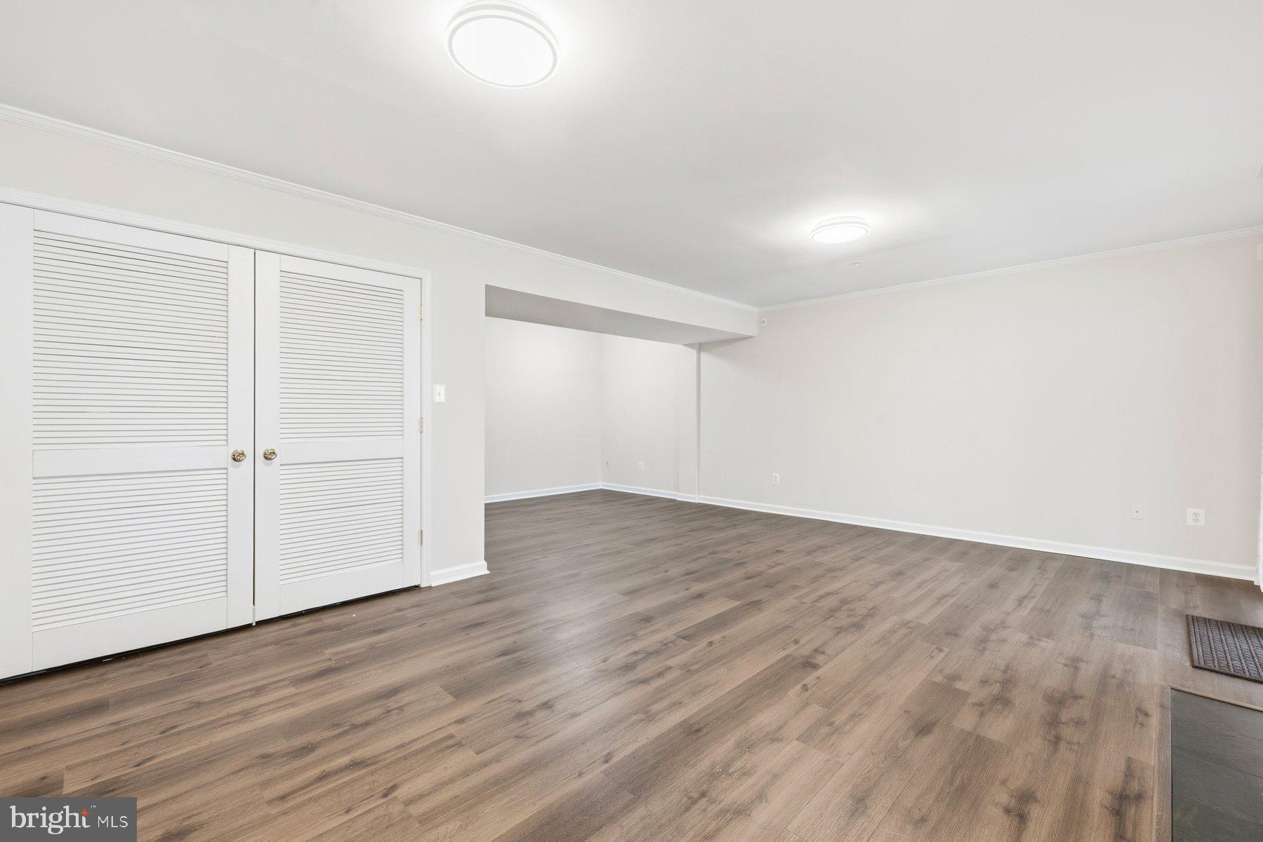 2640 Streamview Drive Odenton, MD 21113 - Photo 36 of 73 an empty room with wooden floor & cabinet and windows